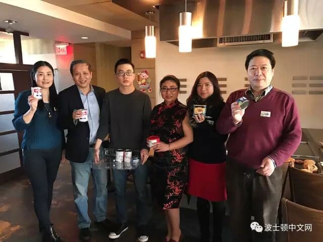 Chapter members holding canned food collected for charity at the 2017 Lunar New Year luncheon