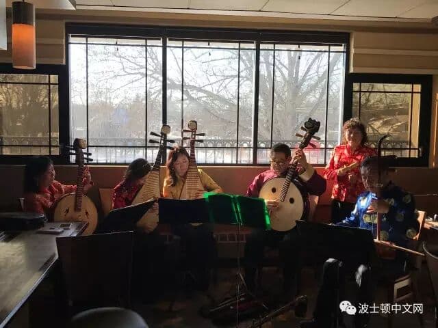 A Chinese folk ensemble playing pipa and erhu by a sunlit window